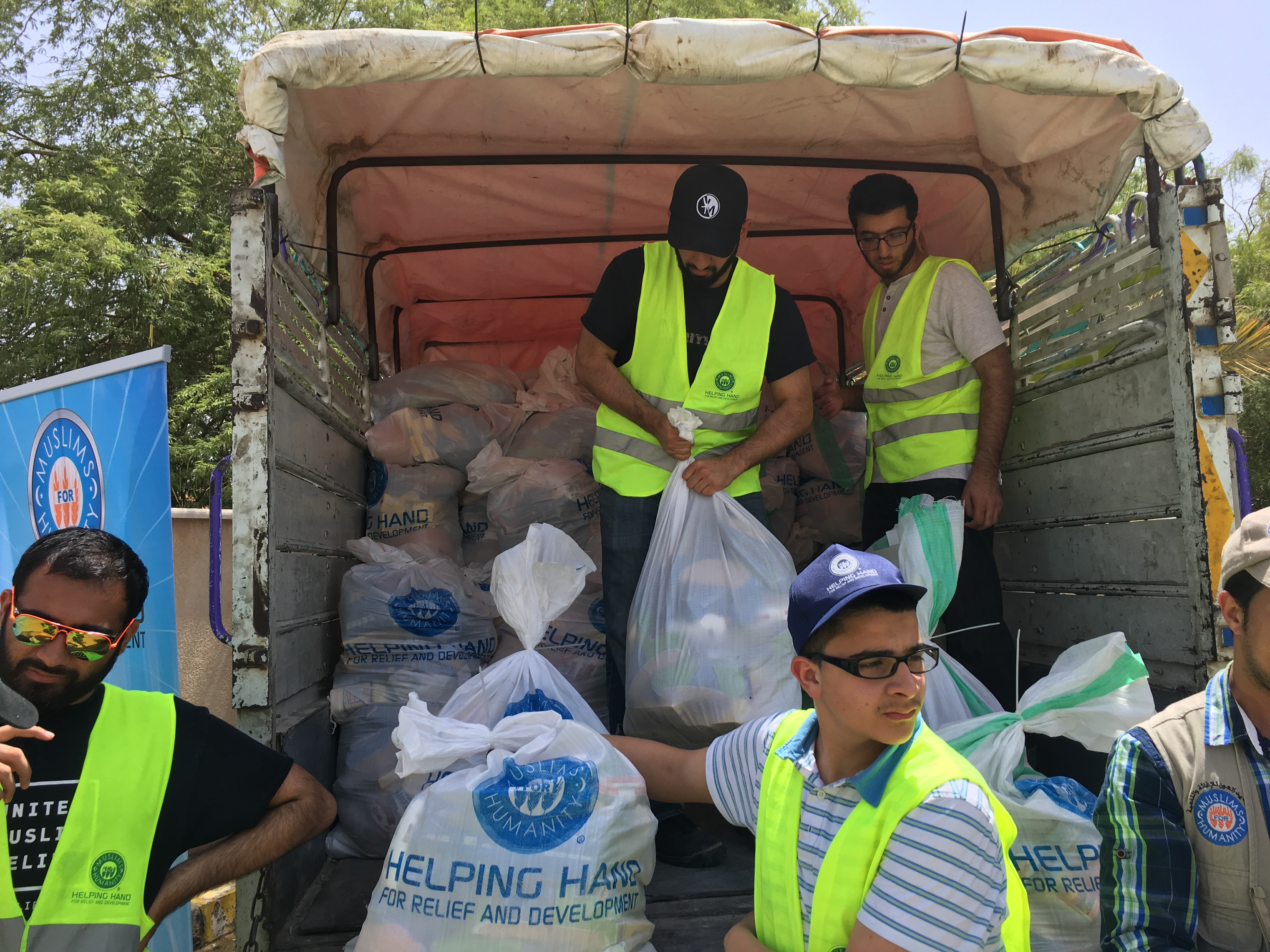 Families receiving food and supplies during the Ramadan Tent event in Jordan